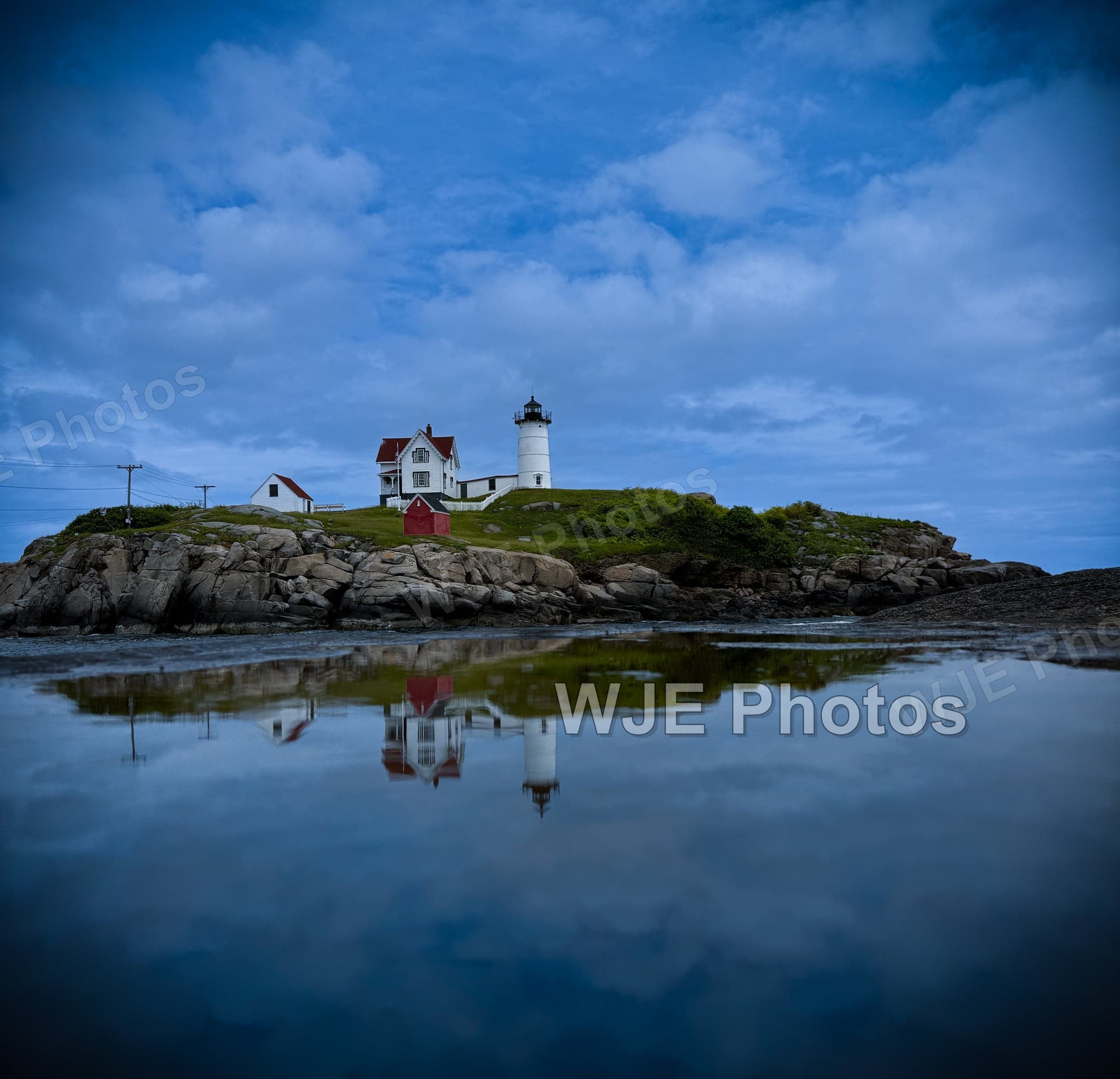 Nubble Lighthouse reflected in tidal water at Cape Neddick, Maine.
